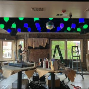 Setting up lights for an event at a bar
